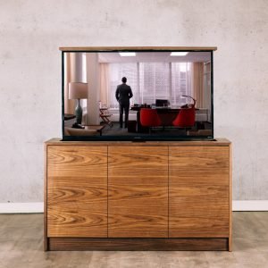An indoor hidden TV lift cabinet in Walnut with waterfall edges and grain matched front doors to hide your TV when not in use.